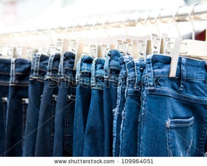stock-photo-row-of-hanged-blue-jeans-in-a-shop-109964051